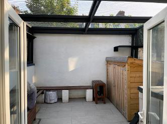 Catio enclosing the entire back garden courtyard in Dublin, Ireland