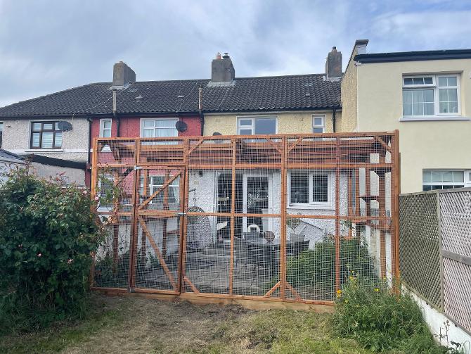 Large varnished Catio attached to house